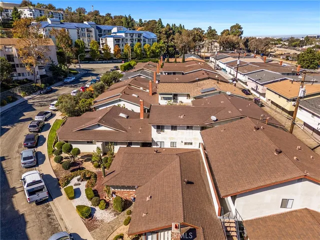 an aerial view of residential houses with outdoor space