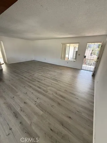 a view of wooden floor and windows in a room