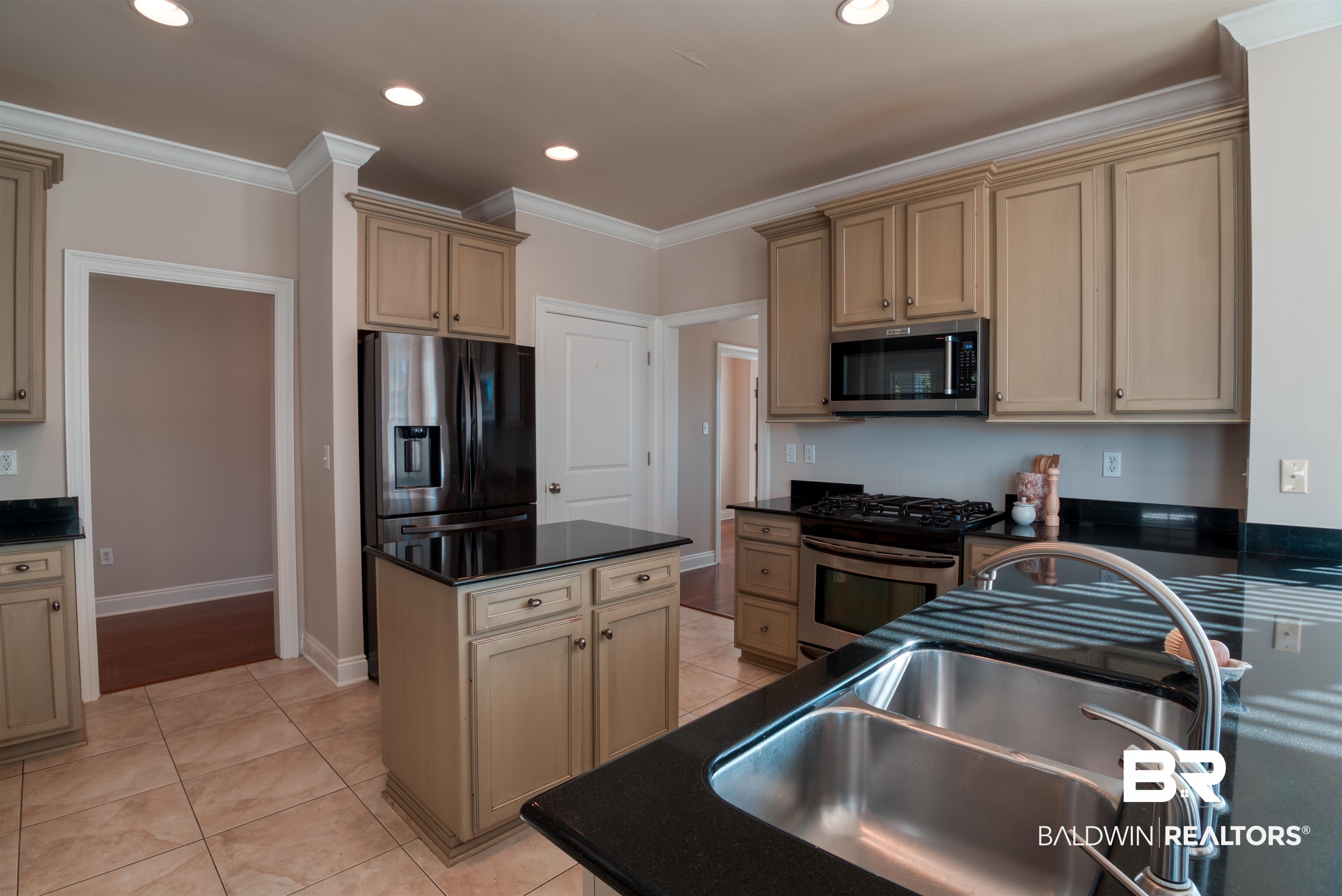 24561 Austin Road Daphne, AL 36526 - Photo 10 of 57 Kitchen with appliances with stainless steel finishes, a kitchen island, crown molding, and sink