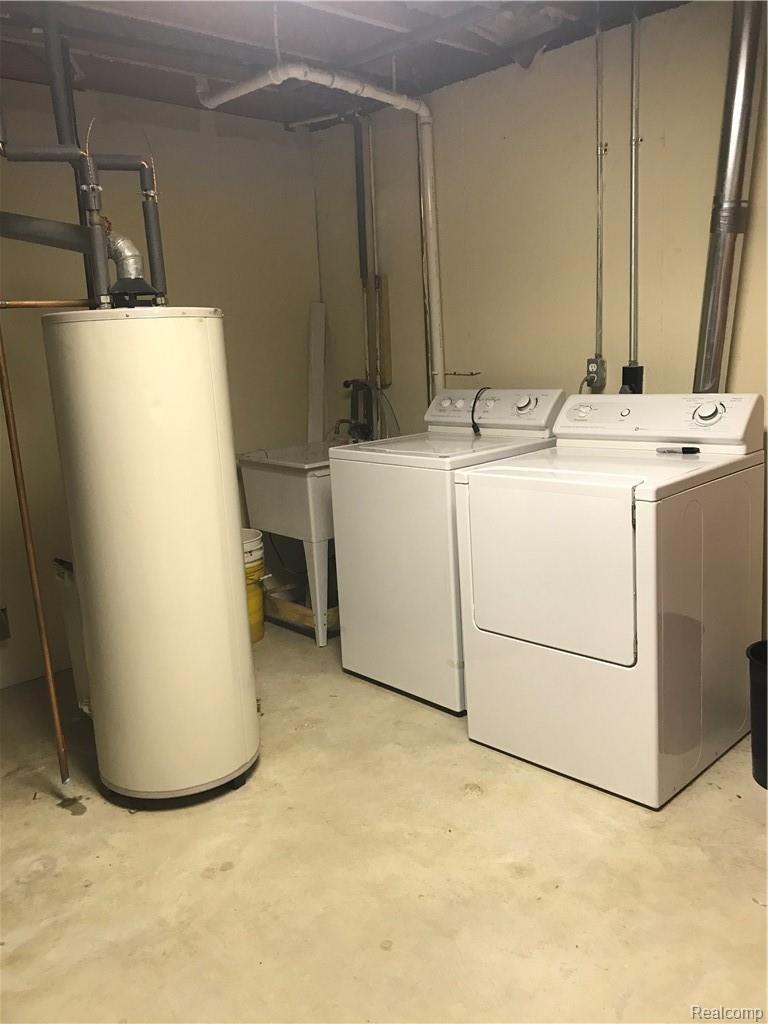 7582 West Beard Road Perry, MI 48872 - Photo 28 of 35 Laundry room, with water heater, furnace and storage shelving!
