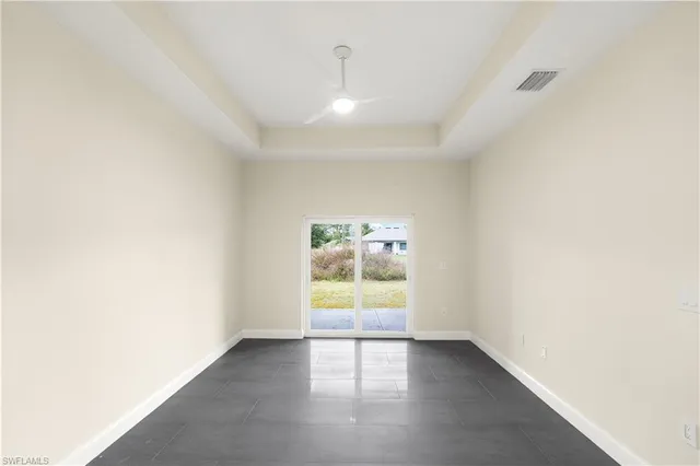 a bathroom with a granite countertop white toilet a sink and shower