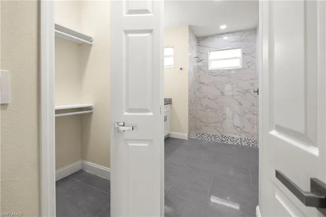 an empty room with large closet and mirror