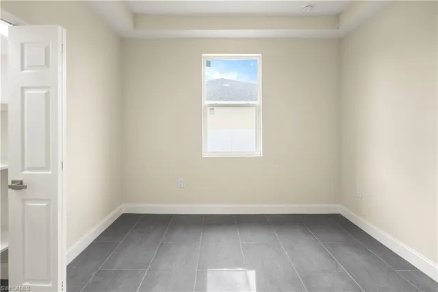an empty room with a bench and closet