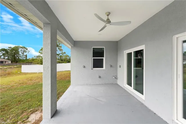 a view of empty room with window and a ceiling fan
