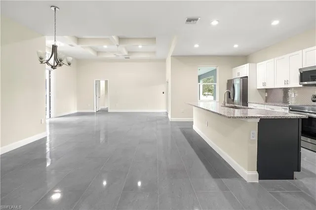a view of a kitchen with a sink and microwave