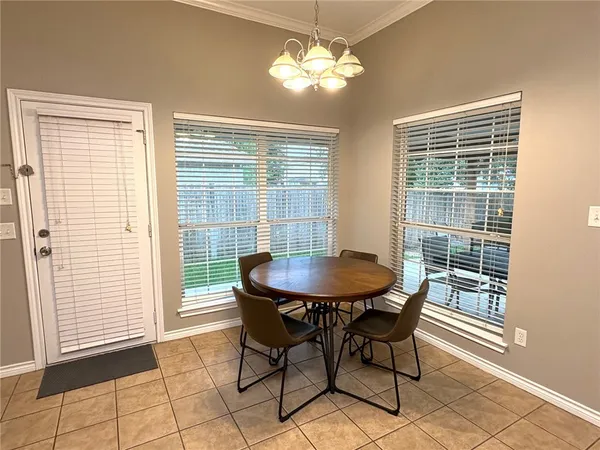 a view of a dining room with furniture and a window