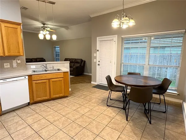 a view of a dining room with furniture and chandelier