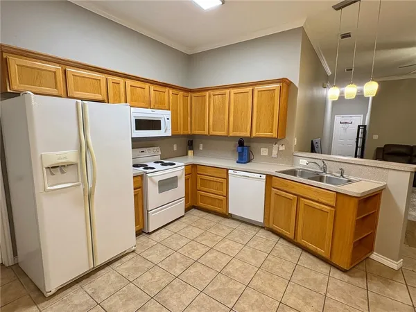 a kitchen with stainless steel appliances a refrigerator sink and cabinets