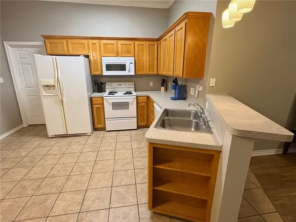 a kitchen with a sink cabinets and appliances