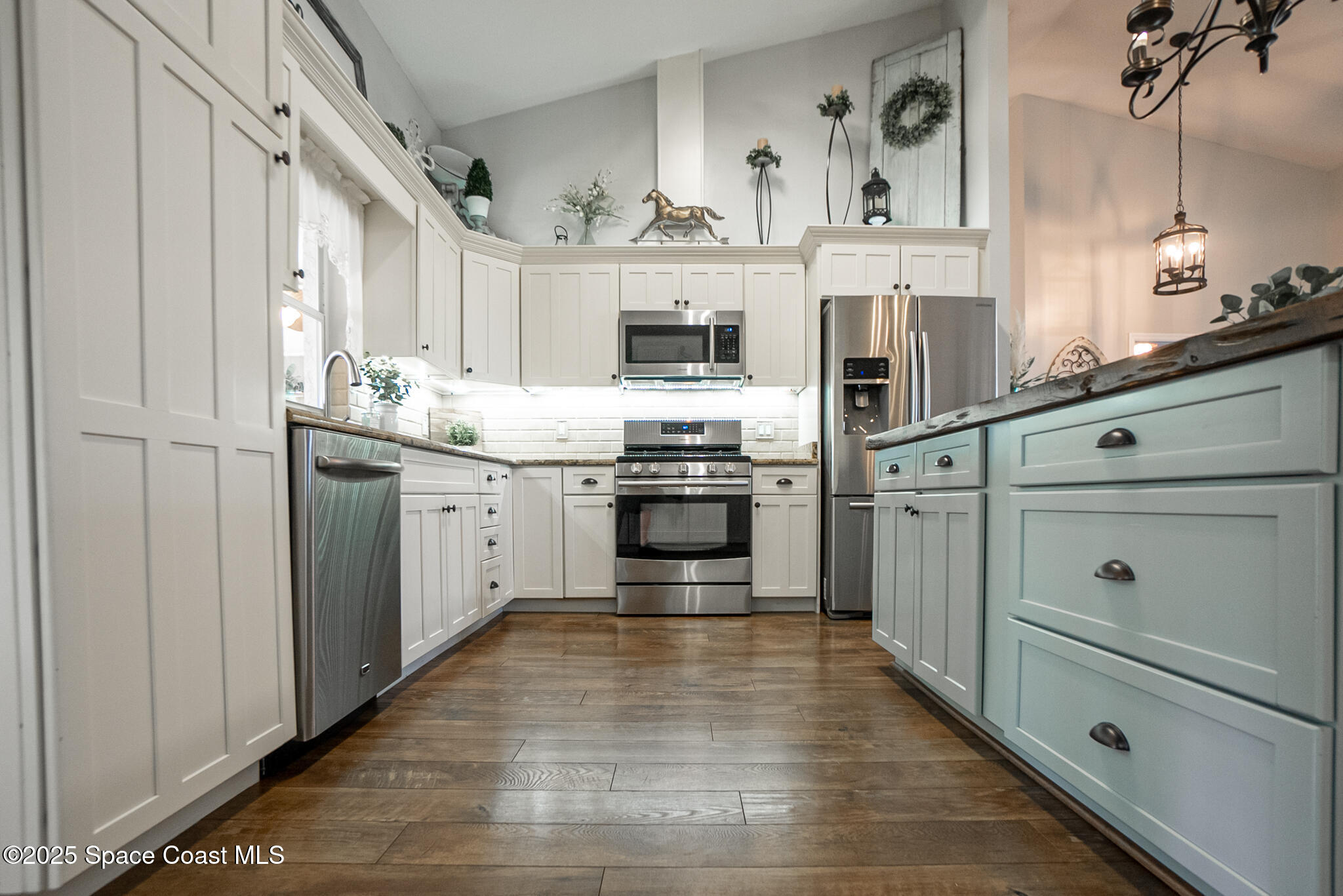 1868 Druliner Road St. Cloud, FL 34771 - Photo 11 of 57 a kitchen with stainless steel appliances granite countertop a stove and a sink