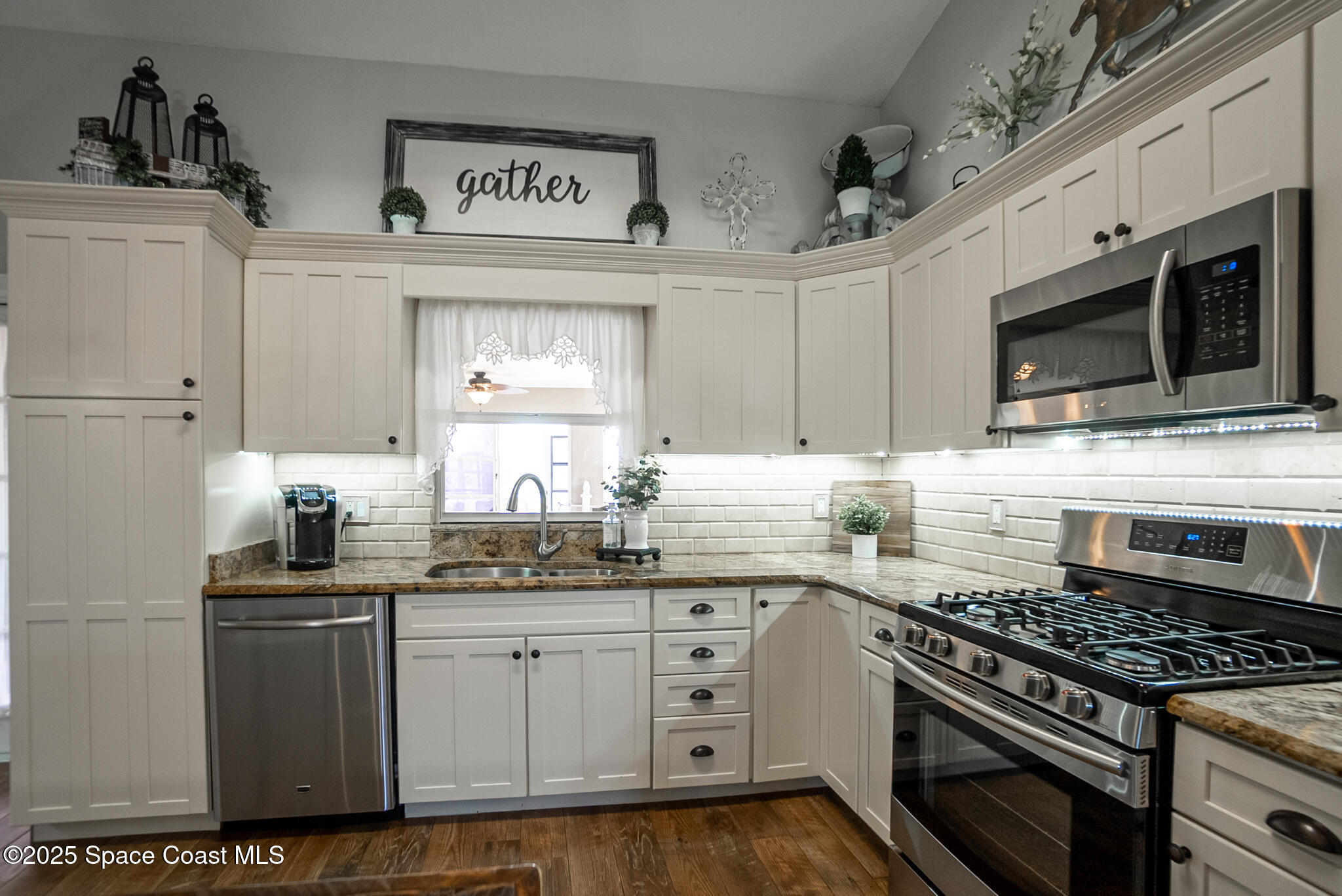 1868 Druliner Road St. Cloud, FL 34771 - Photo 15 of 57 a kitchen with stainless steel appliances granite countertop a stove a sink and a microwave