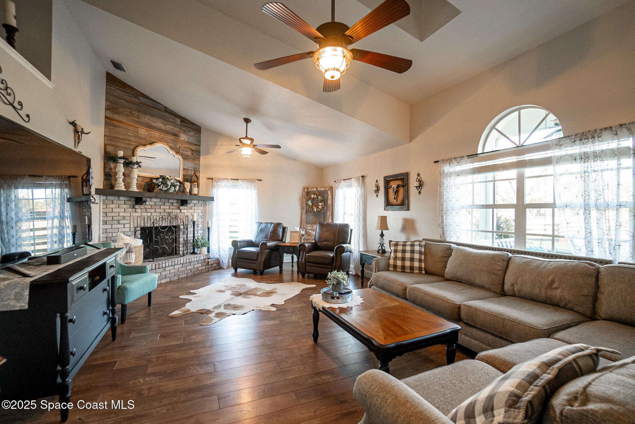 1868 Druliner Road St. Cloud, FL 34771 - Photo 17 of 57 a living room with furniture a fireplace and a large window