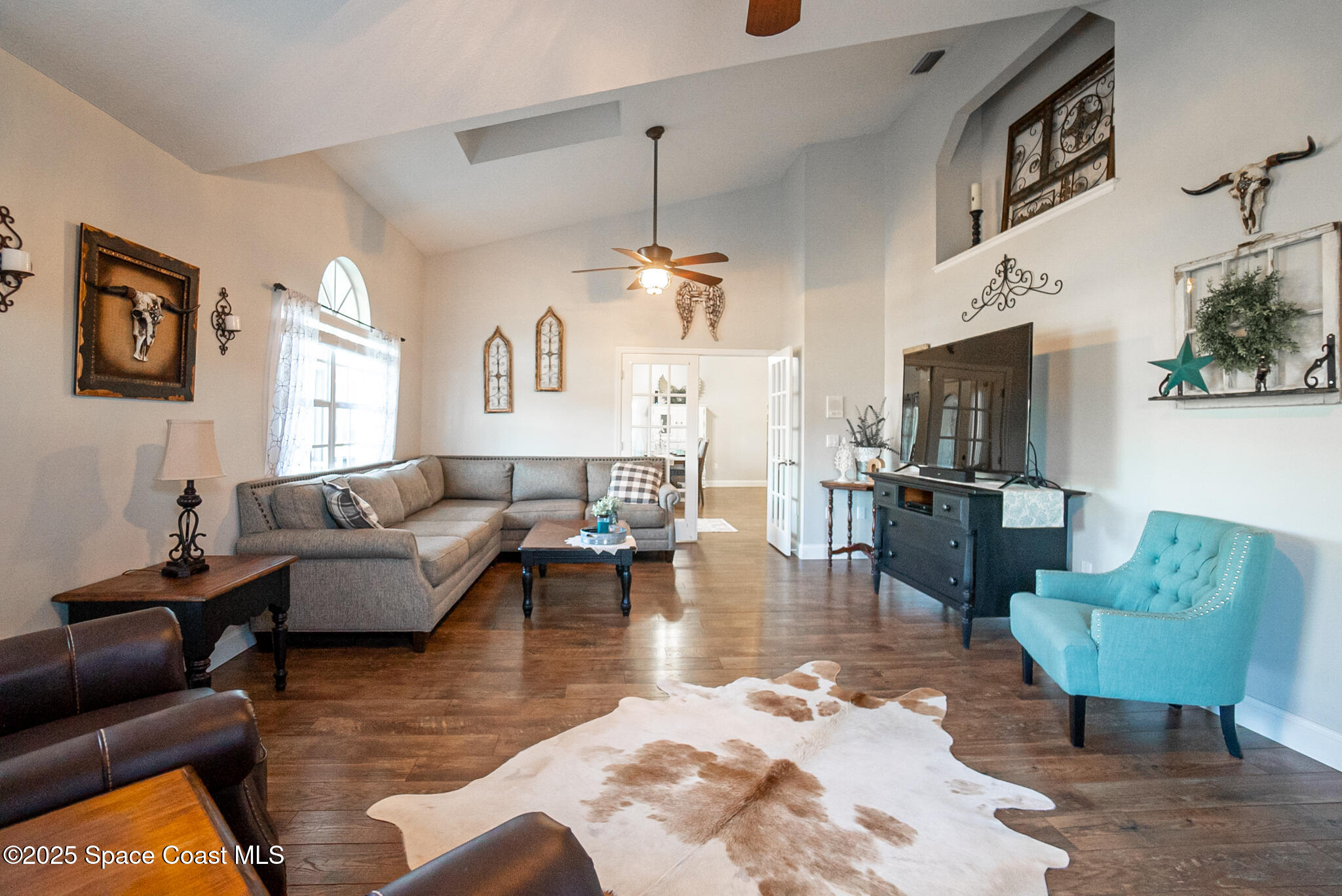 1868 Druliner Road St. Cloud, FL 34771 - Photo 18 of 57 a living room with furniture wooden floor and a chandelier