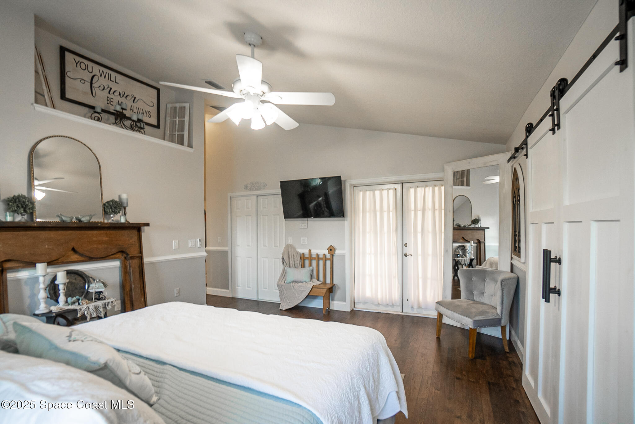 1868 Druliner Road St. Cloud, FL 34771 - Photo 20 of 57 a bedroom with a bed and a chandelier