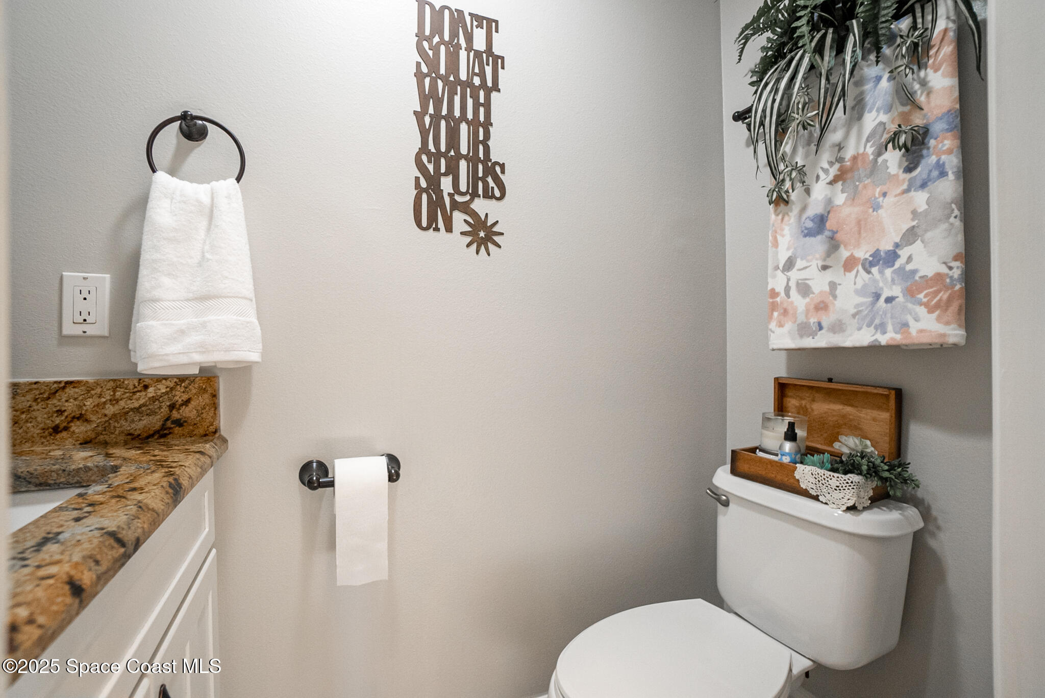 1868 Druliner Road St. Cloud, FL 34771 - Photo 26 of 57 a bathroom with a toilet sink and mirror