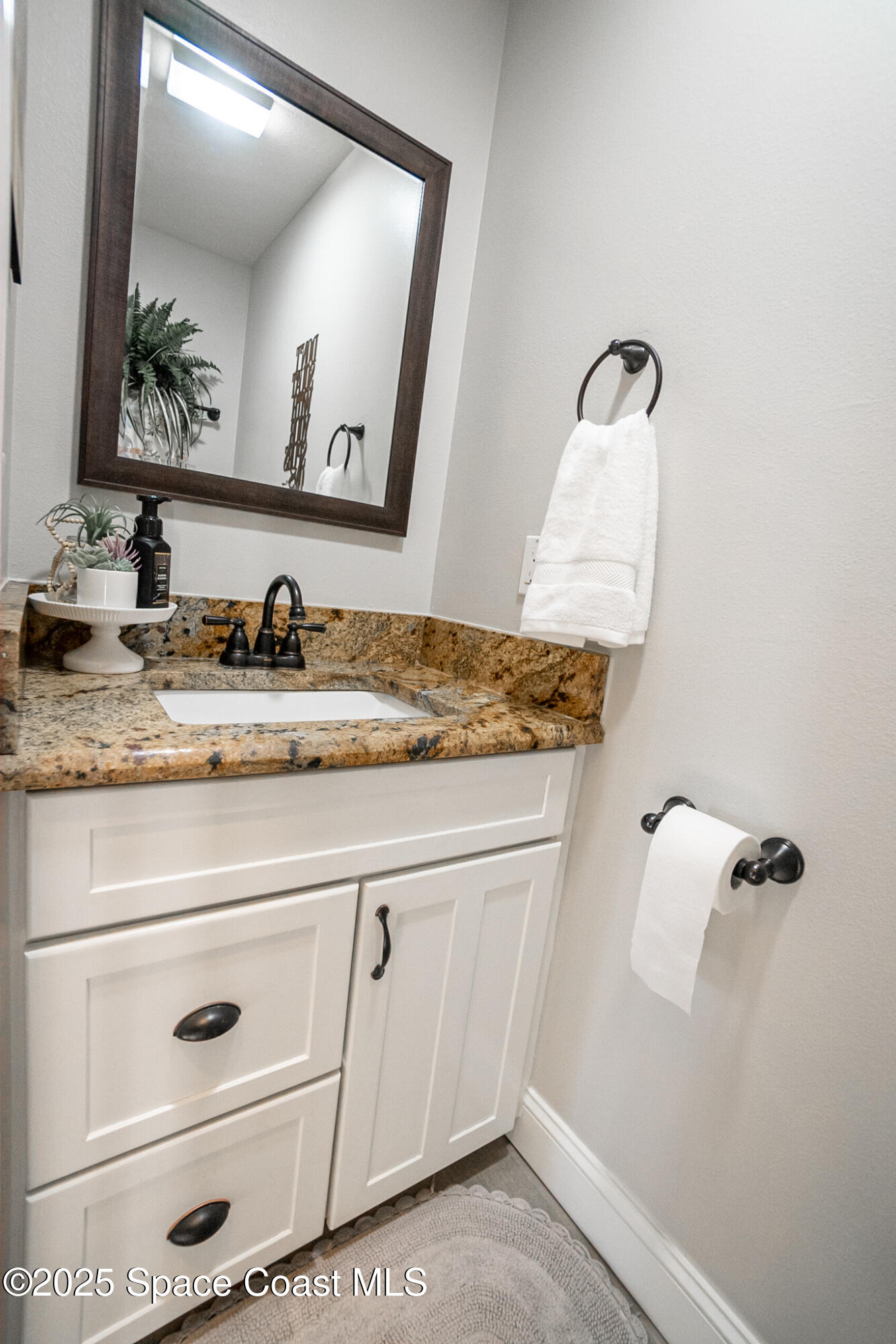 1868 Druliner Road St. Cloud, FL 34771 - Photo 27 of 57 a bathroom with a sink and mirror