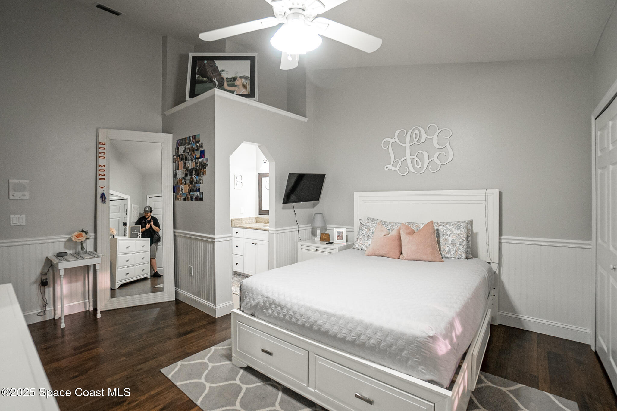 1868 Druliner Road St. Cloud, FL 34771 - Photo 30 of 57 a bedroom with a bed and a flat tv screen on dresser