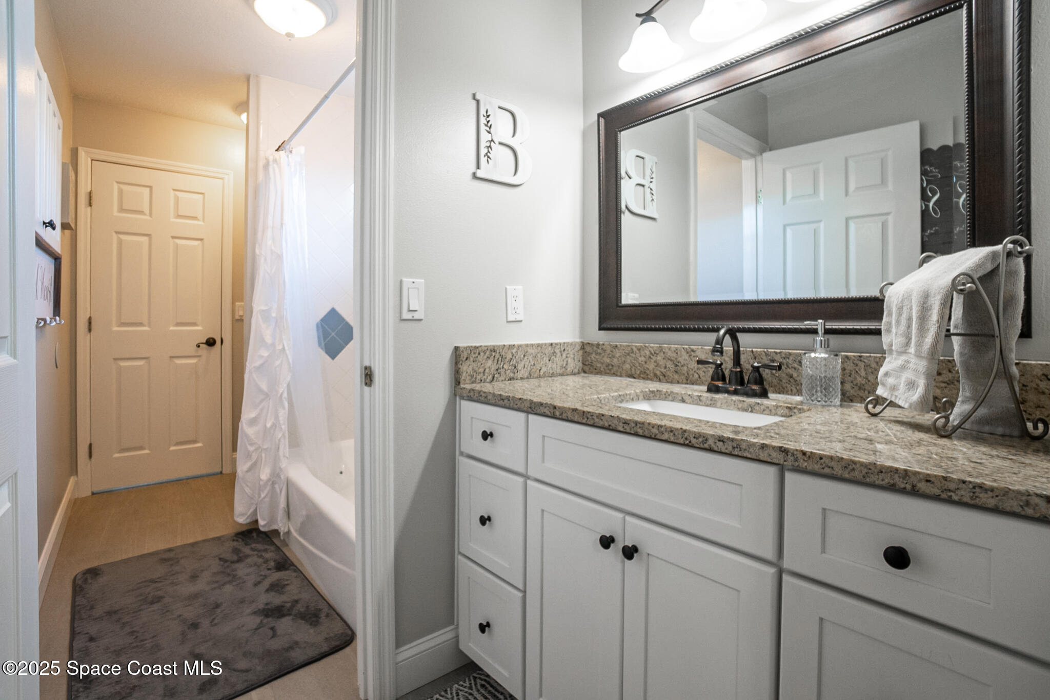 1868 Druliner Road St. Cloud, FL 34771 - Photo 32 of 57 a bathroom with a sink and a mirror