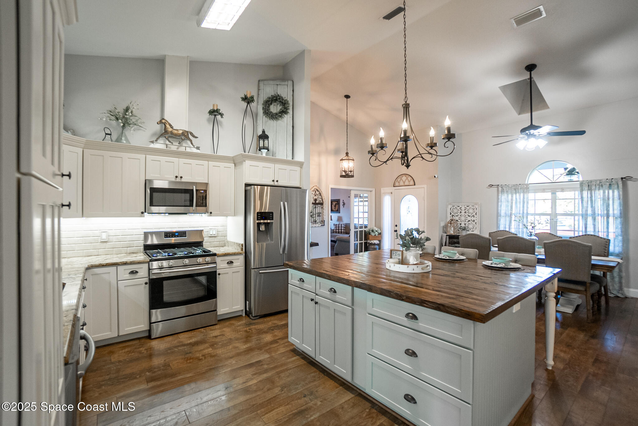 1868 Druliner Road St. Cloud, FL 34771 - Photo 7 of 57 a kitchen with stainless steel appliances granite countertop a stove oven and a refrigerator
