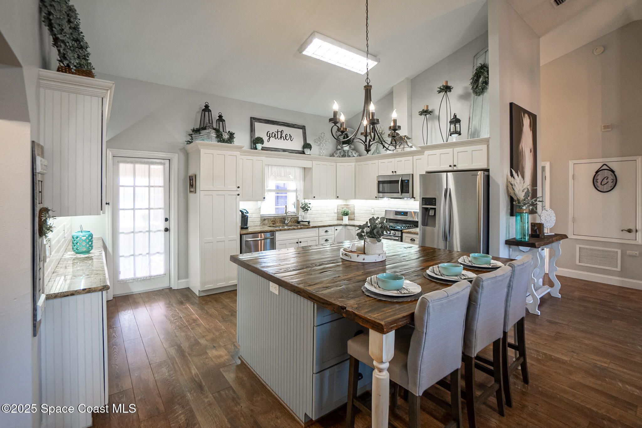 1868 Druliner Road St. Cloud, FL 34771 - Photo 10 of 57 a dining room with furniture a kitchen and chandelier