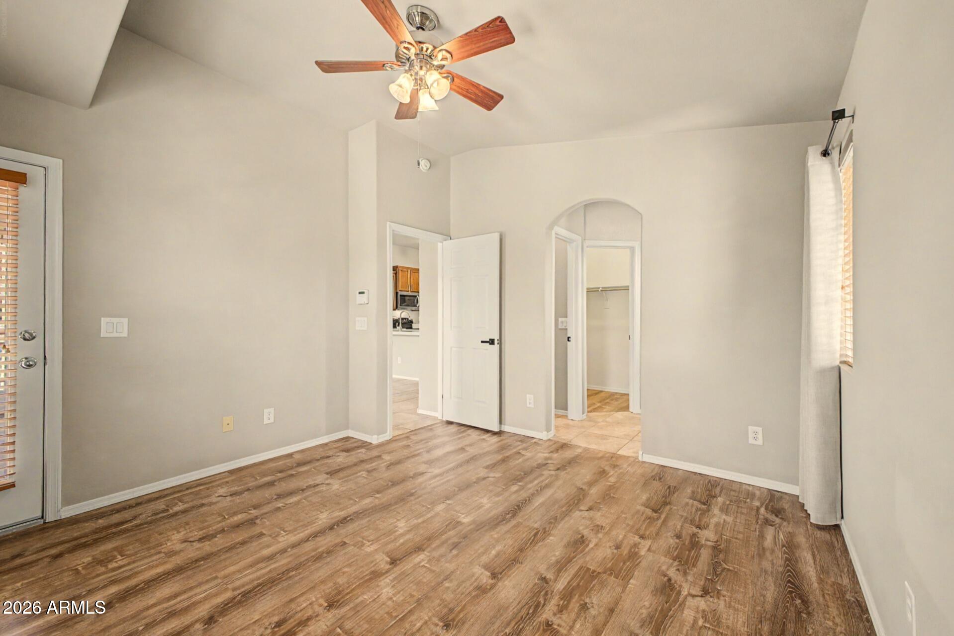 2725 East Mine Creek Road, Unit 2172 Phoenix, AZ 85024 - Photo 17 of 28 a view of a big room with wooden floor and cabinet
