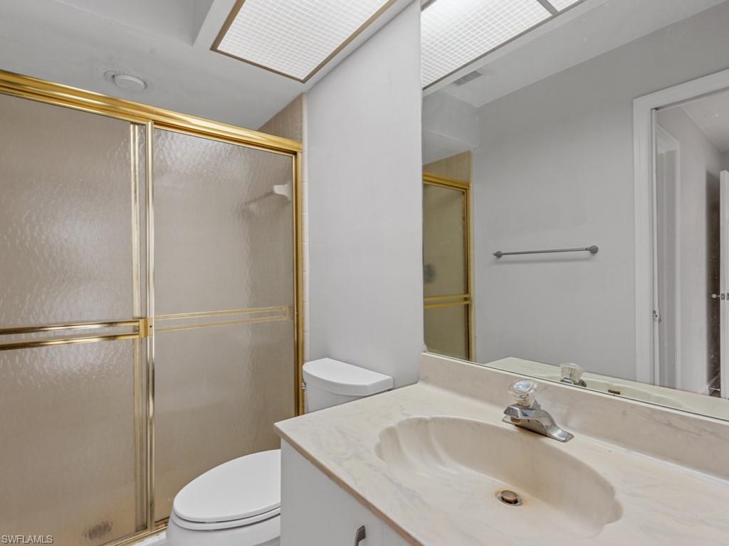 7016 Trail Boulevard Naples, FL 34108 - Photo 16 of 26 a bathroom with a sink and a mirror