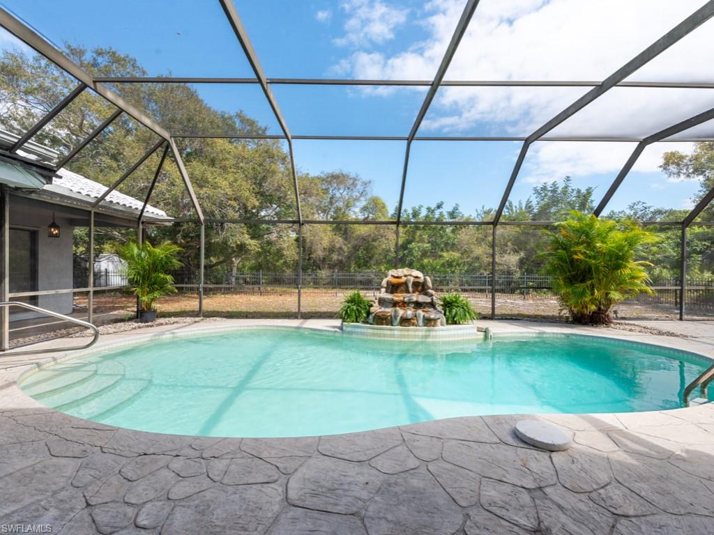 7016 Trail Boulevard Naples, FL 34108 - Photo 23 of 26 a view of a swimming pool with a patio