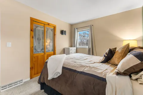 a bedroom with a bed and a window