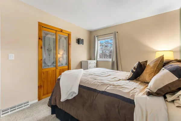 a bedroom with a bed and a window