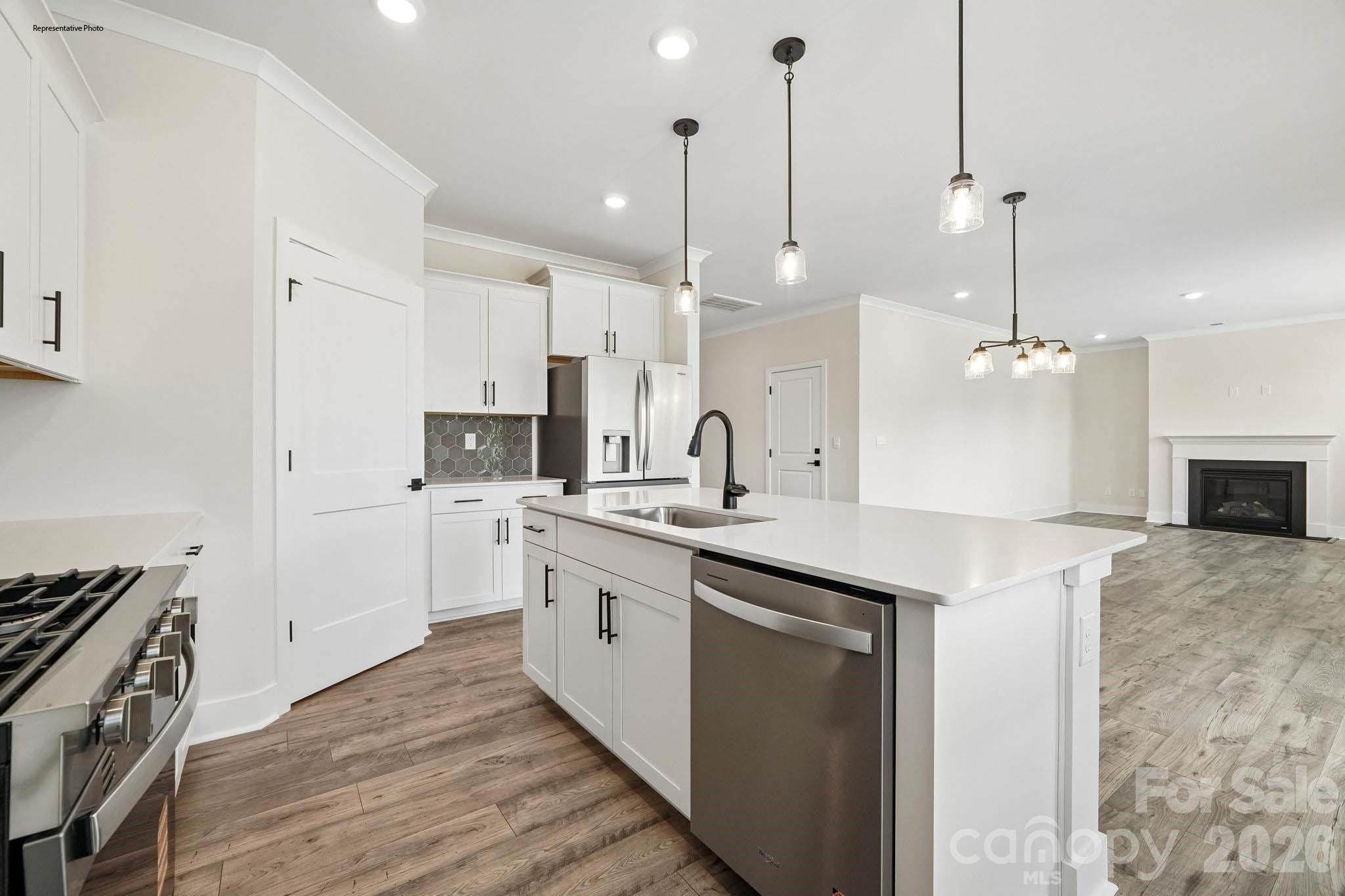 541 Mahogany Road York, SC 29745 - Photo 12 of 32 a kitchen with kitchen island a sink stainless steel appliances and cabinets
