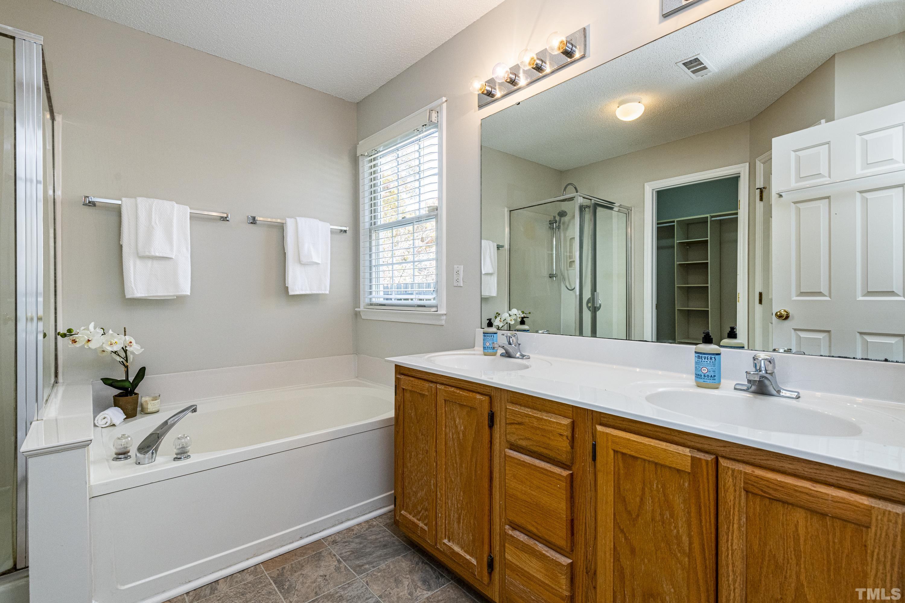 5317 Tilford Lane Raleigh, NC 27613 - Photo 18 of 29 a bathroom with a tub sink and mirror