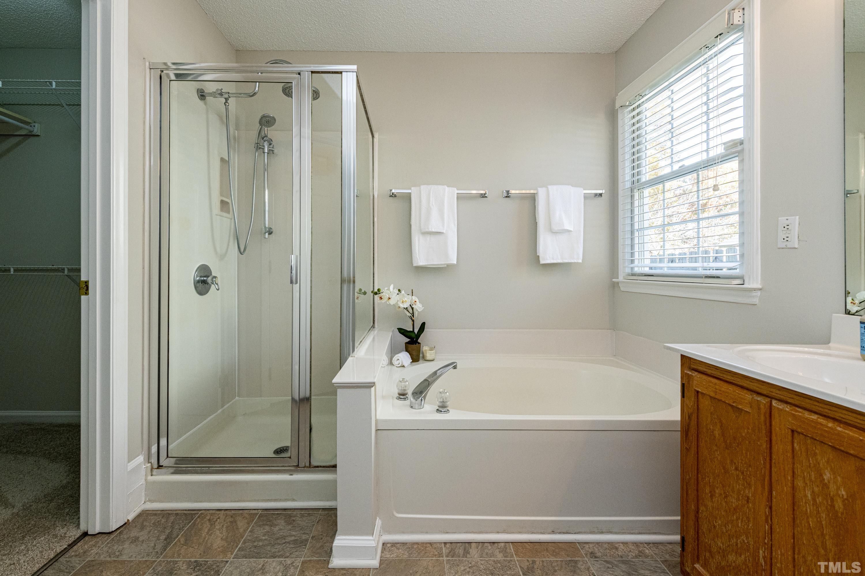 5317 Tilford Lane Raleigh, NC 27613 - Photo 19 of 29 a white bath tub sitting next to a shower