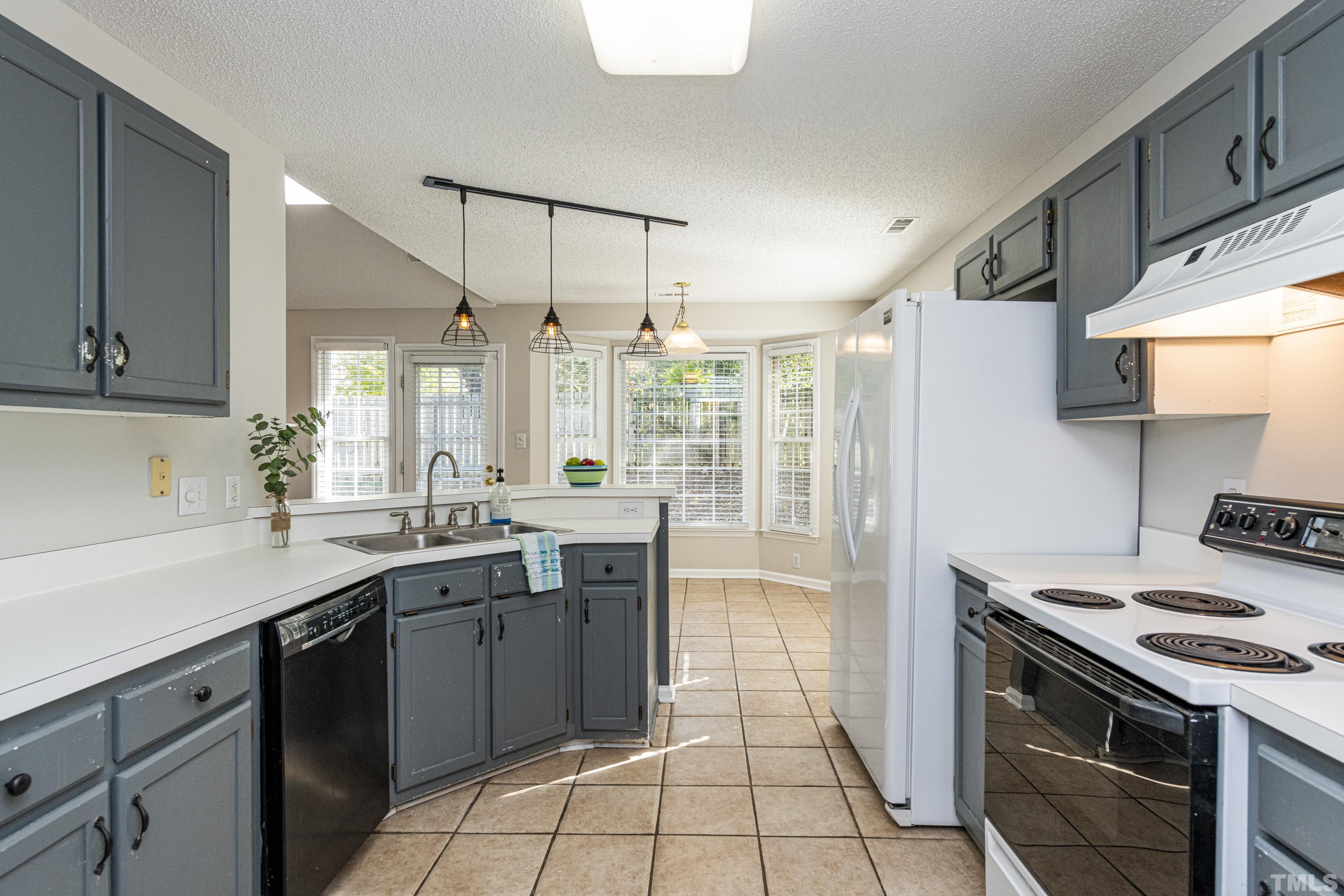 5317 Tilford Lane Raleigh, NC 27613 - Photo 3 of 29 a kitchen with a sink stove and cabinets
