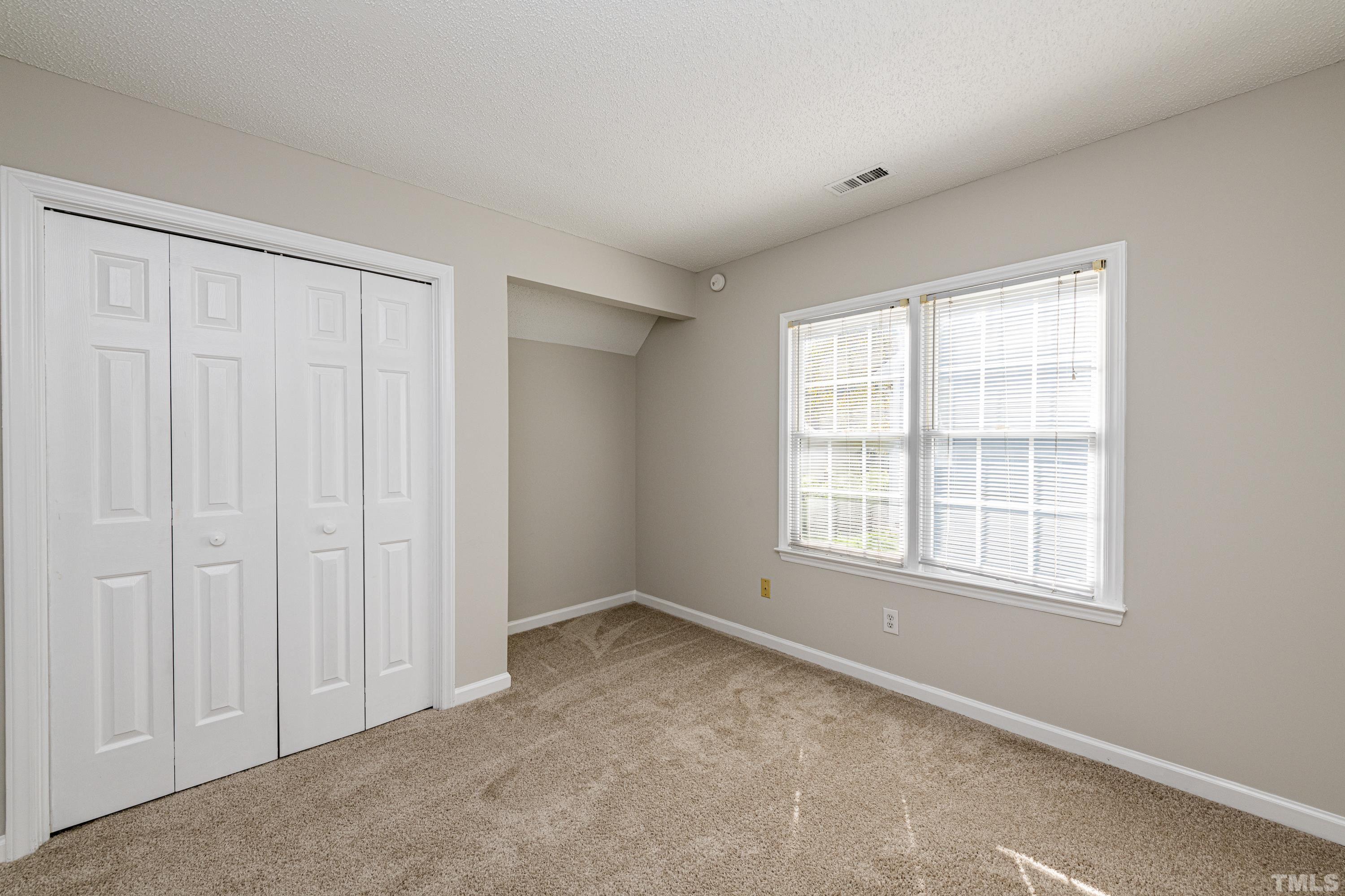 5317 Tilford Lane Raleigh, NC 27613 - Photo 23 of 29 an empty room with a window