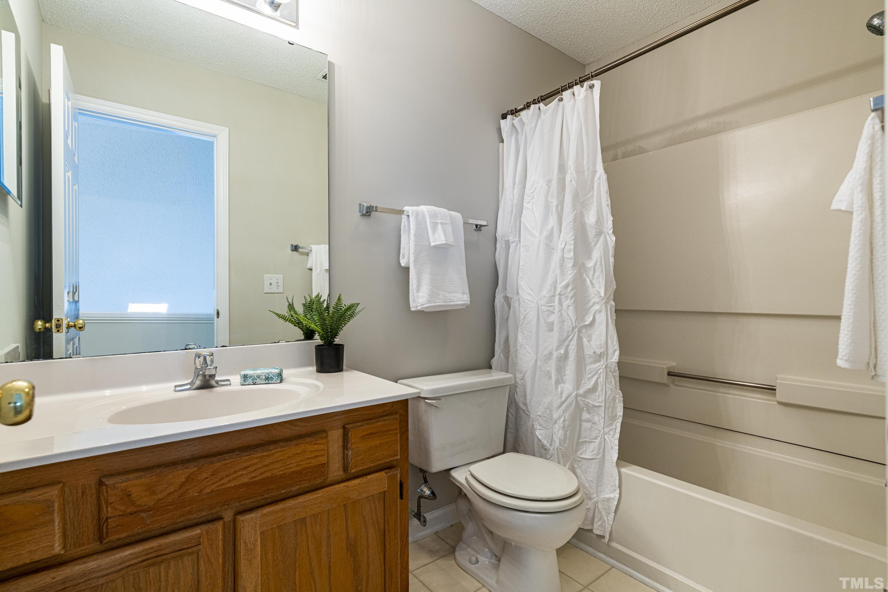 5317 Tilford Lane Raleigh, NC 27613 - Photo 24 of 29 a bathroom with a sink a toilet and shower