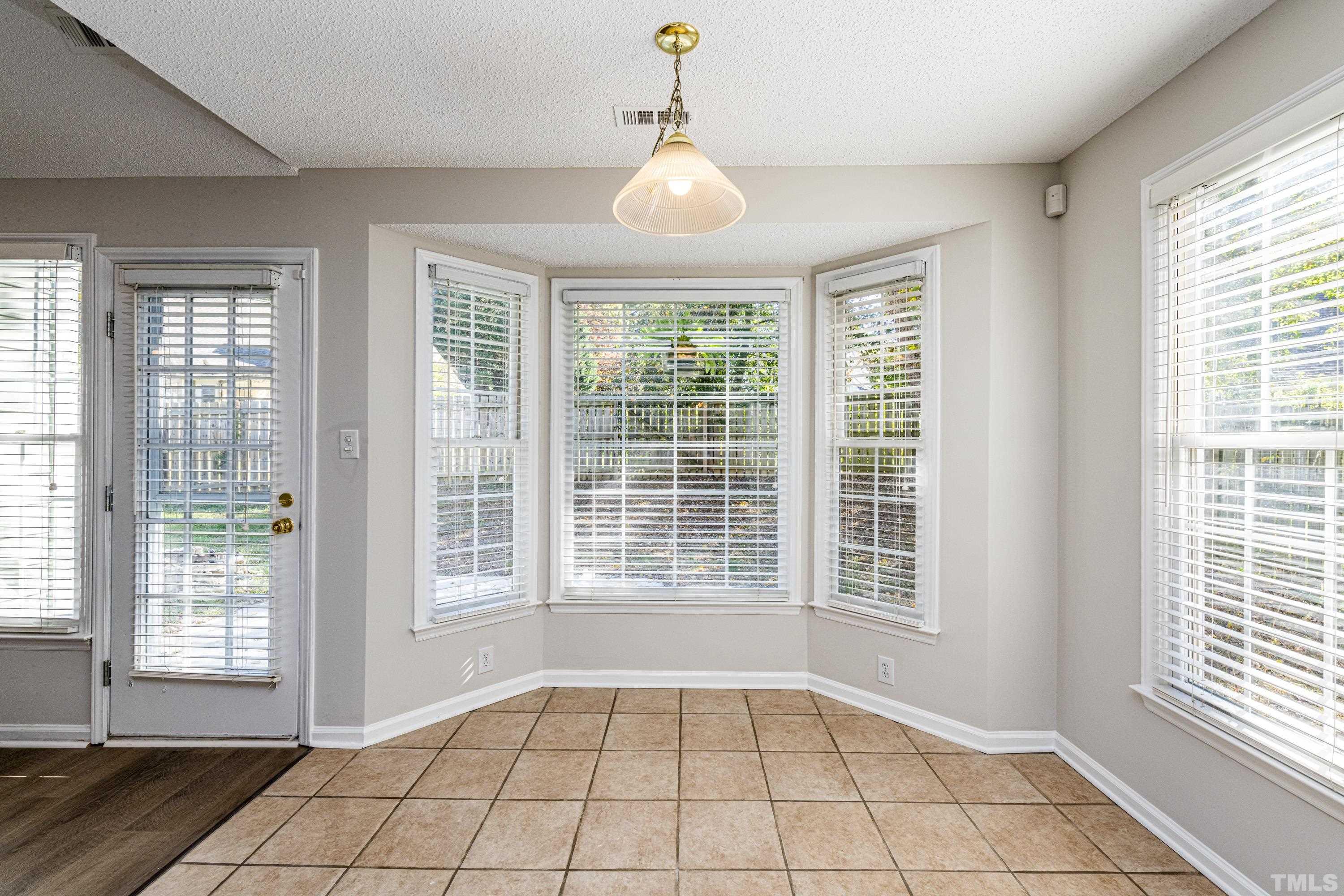5317 Tilford Lane Raleigh, NC 27613 - Photo 7 of 29 a view of an empty room with a window