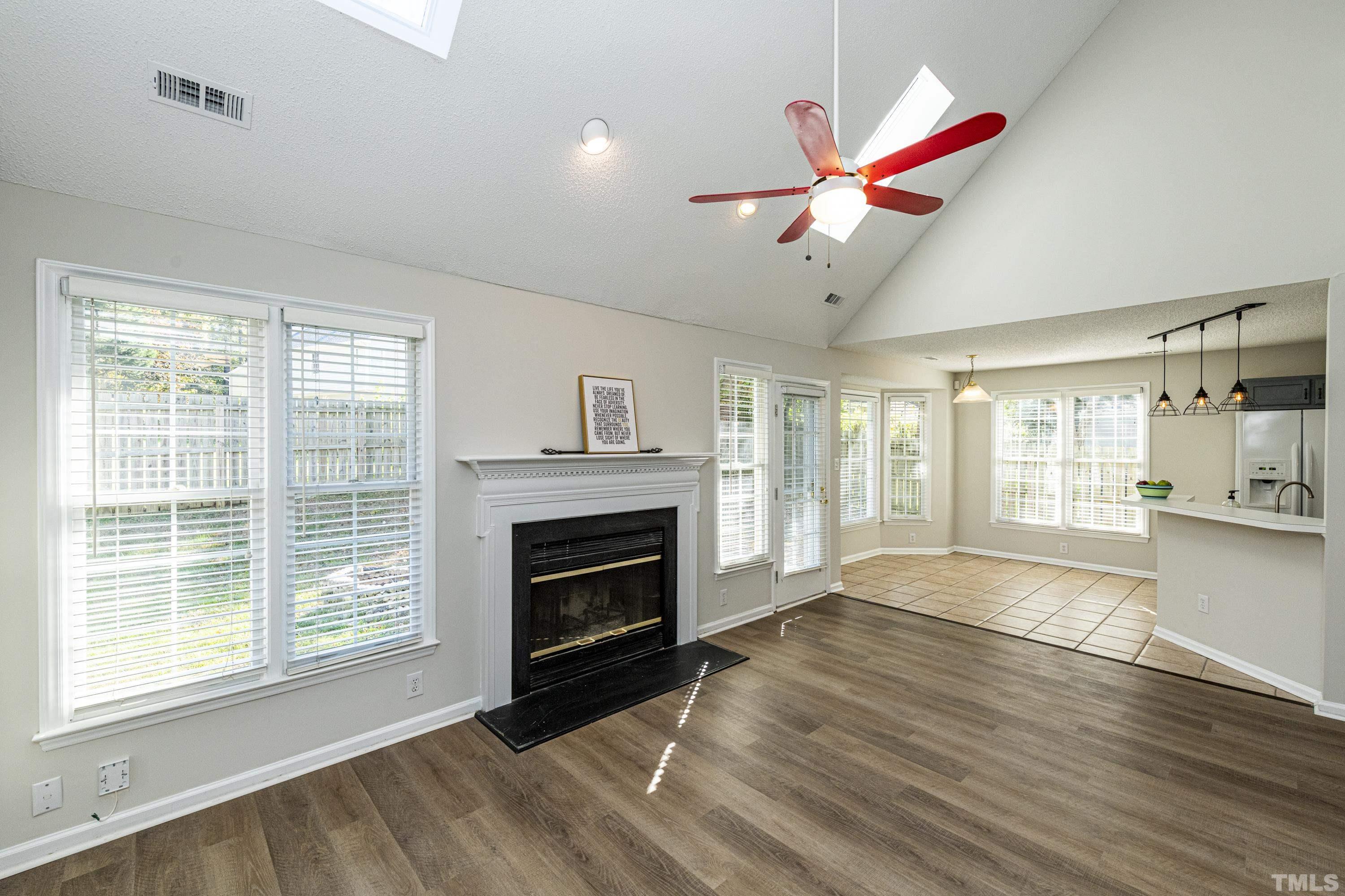 5317 Tilford Lane Raleigh, NC 27613 - Photo 8 of 29 a view of an empty room with window and wooden floor