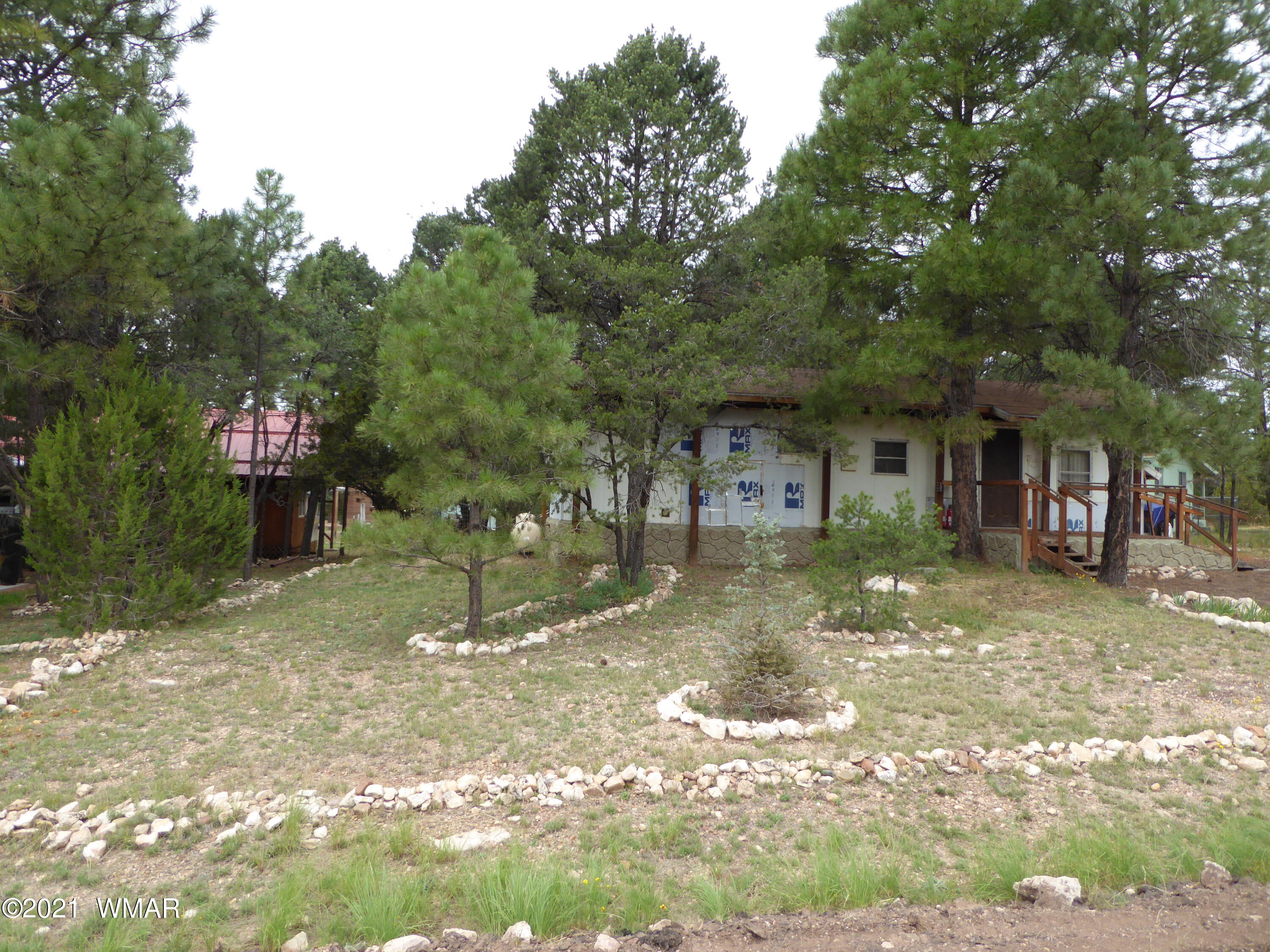 3326 Buckskin Road Overgaard, AZ 85933 - Photo 1 of 2 a front view of a house with a yard