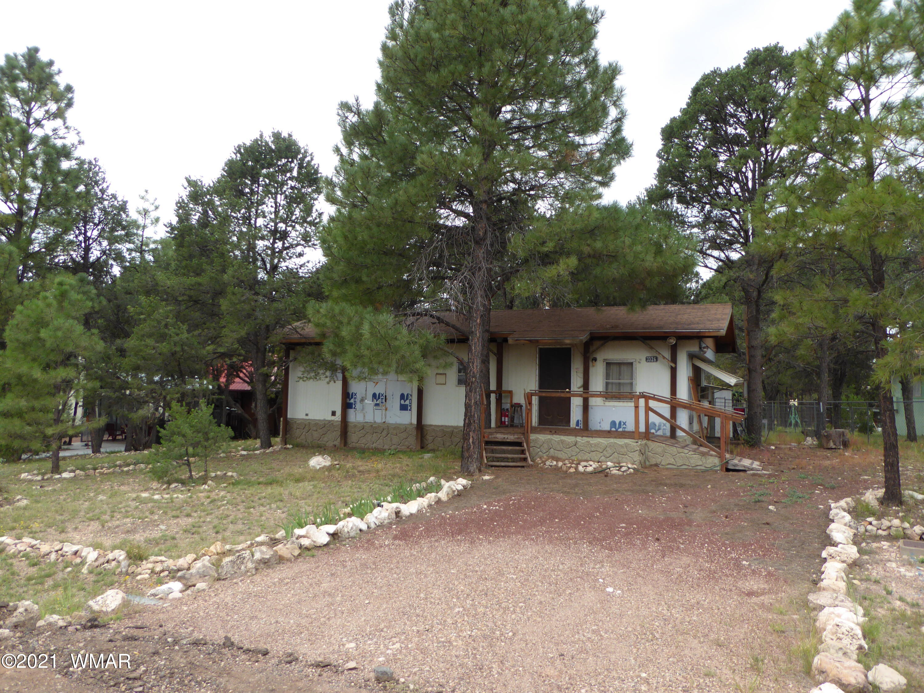3326 Buckskin Road Overgaard, AZ 85933 - Photo 2 of 2 a front view of a house with a yard