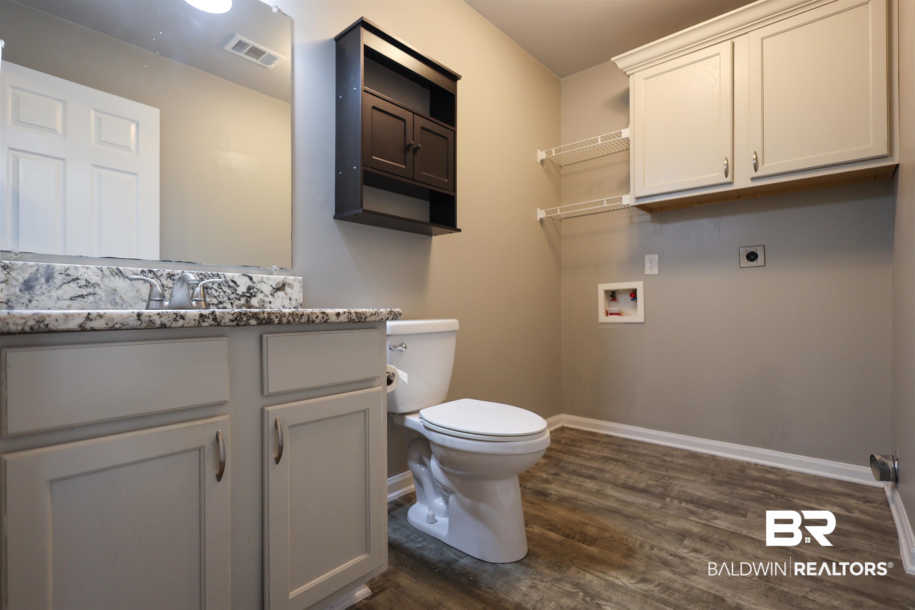 1517 Regency Road, Unit 125 Gulf Shores, AL 36542 - Photo 16 of 26 Bathroom with vanity and dark wood-style floors