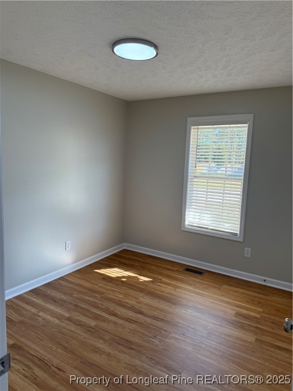 31 Buckboard Lane Autryville, NC 28318 - Photo 11 of 32 a view of an empty room with wooden floor and a window