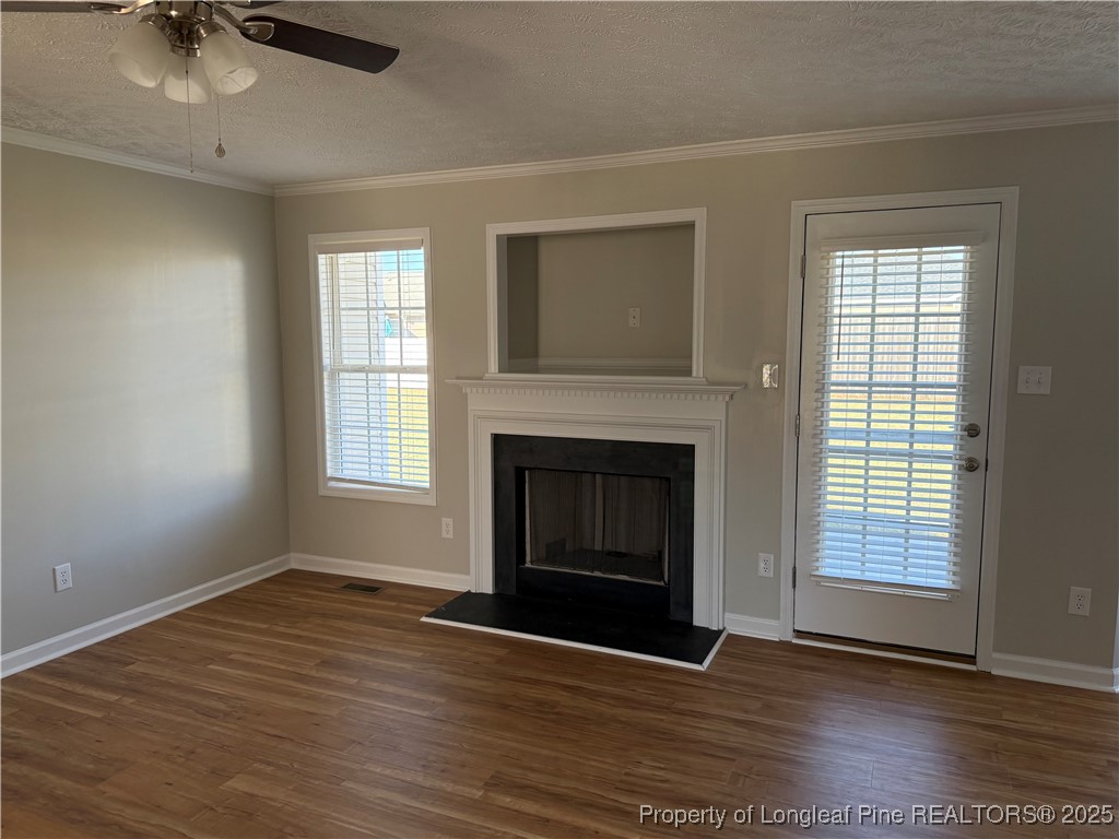 31 Buckboard Lane Autryville, NC 28318 - Photo 5 of 32 wooden floor fireplace and windows in an empty room