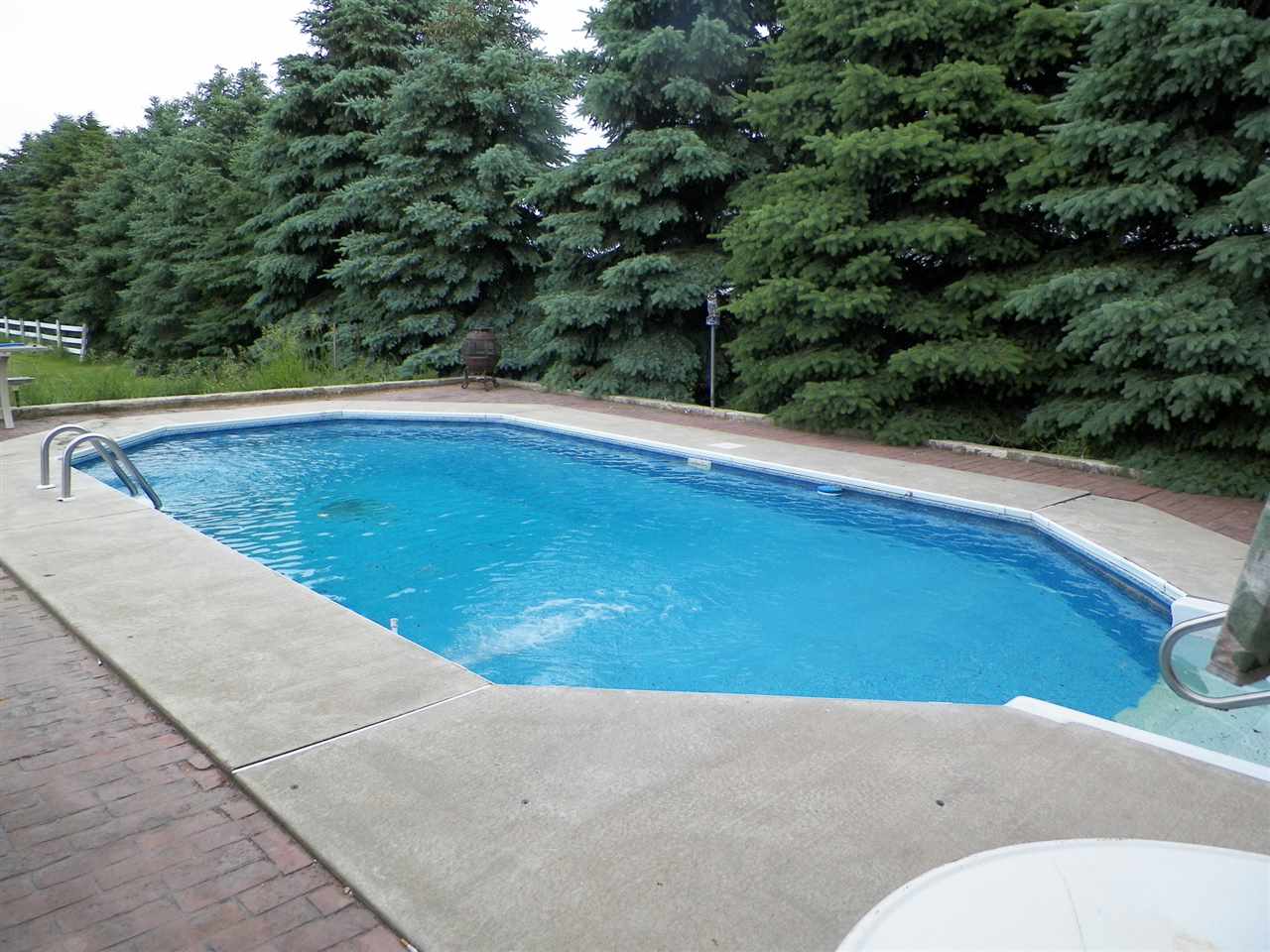 11483 North Tower Road Byron, IL 61010 - Photo 11 of 17 a view of a swimming pool with a yard
