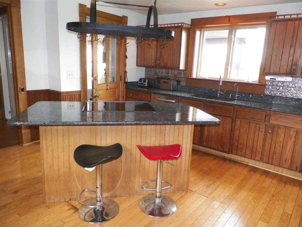 11483 North Tower Road Byron, IL 61010 - Photo 3 of 17 a kitchen with granite countertop a sink a window and cabinets