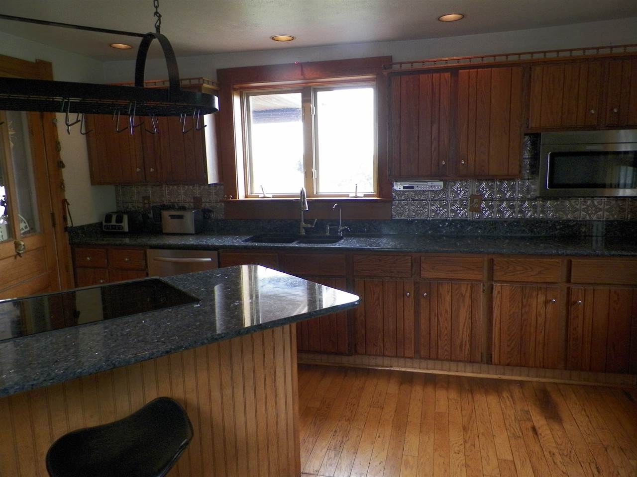 11483 North Tower Road Byron, IL 61010 - Photo 5 of 17 a kitchen with stainless steel appliances granite countertop wooden cabinets a stove a sink and a microwave
