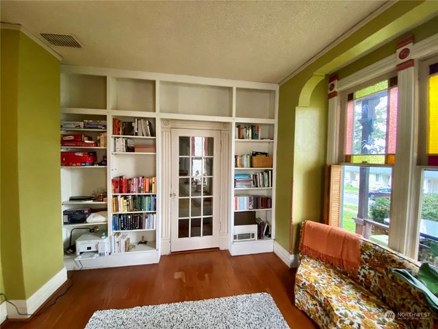 a bedroom with furniture and a book shelf