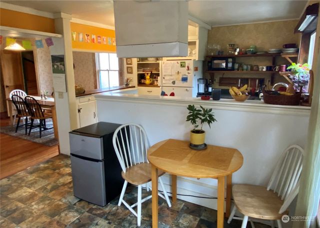 a kitchen with stainless steel appliances a refrigerator and a cabinets