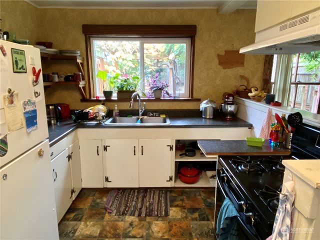 a kitchen with a stove and a sink
