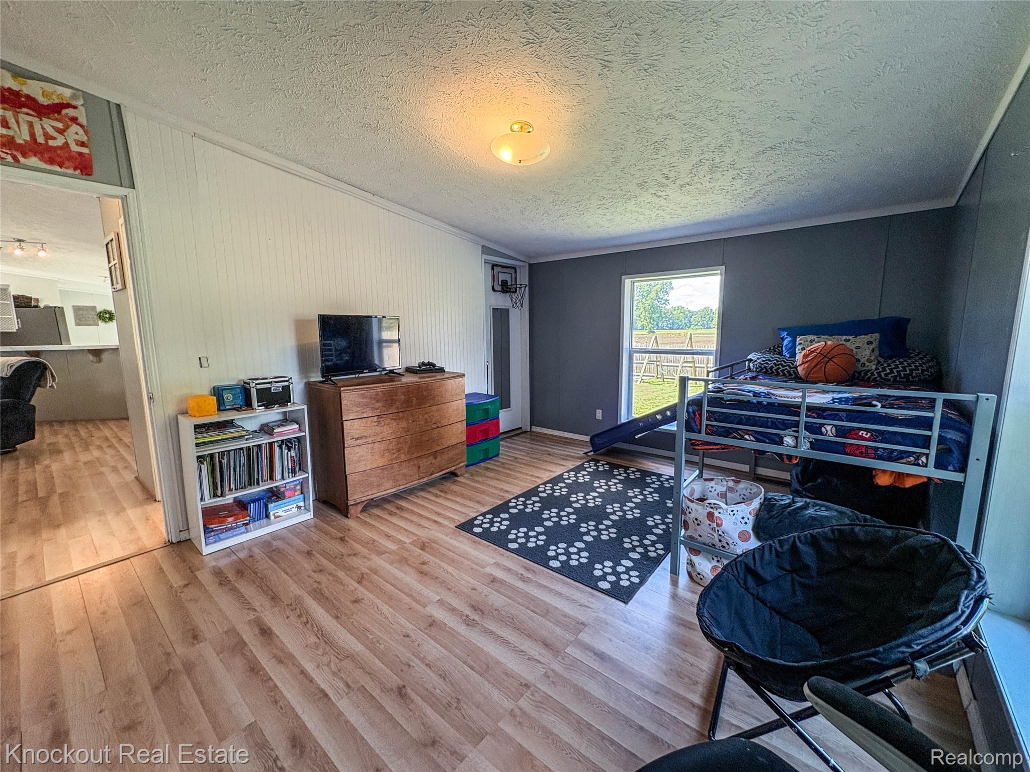 7760 Bell Road Birch Run, MI 48415 - Photo 45 of 68 Room featuring wood-finish flooring, a neutral ceiling, and a window offering natural light