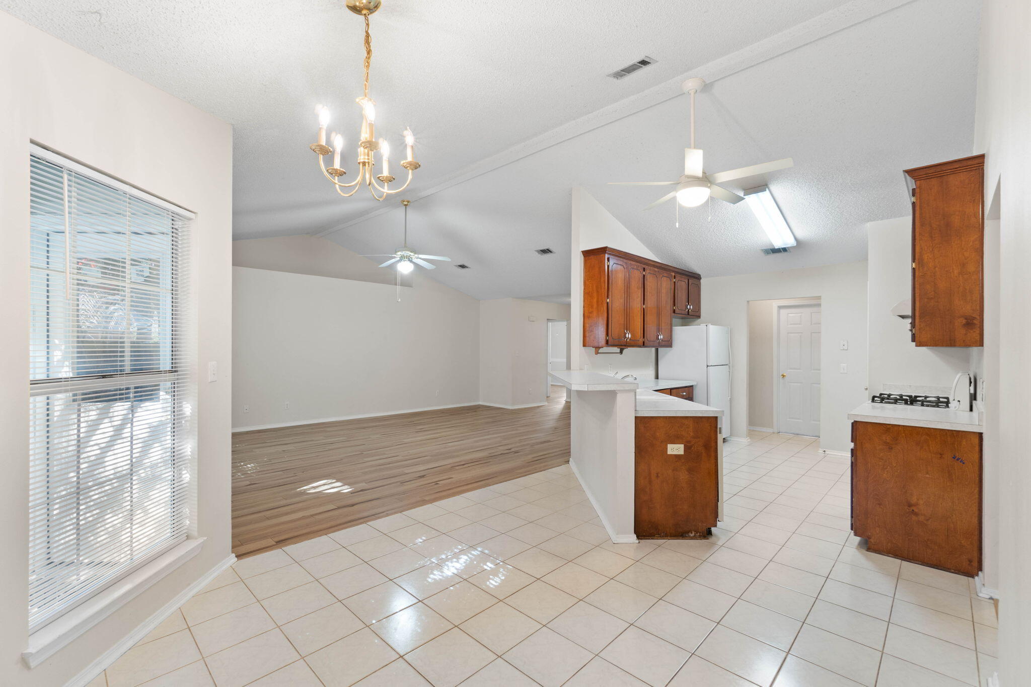 4591 Scarlet Drive Crestview, FL 32539 - Photo 11 of 37 a living room with furniture and a chandelier